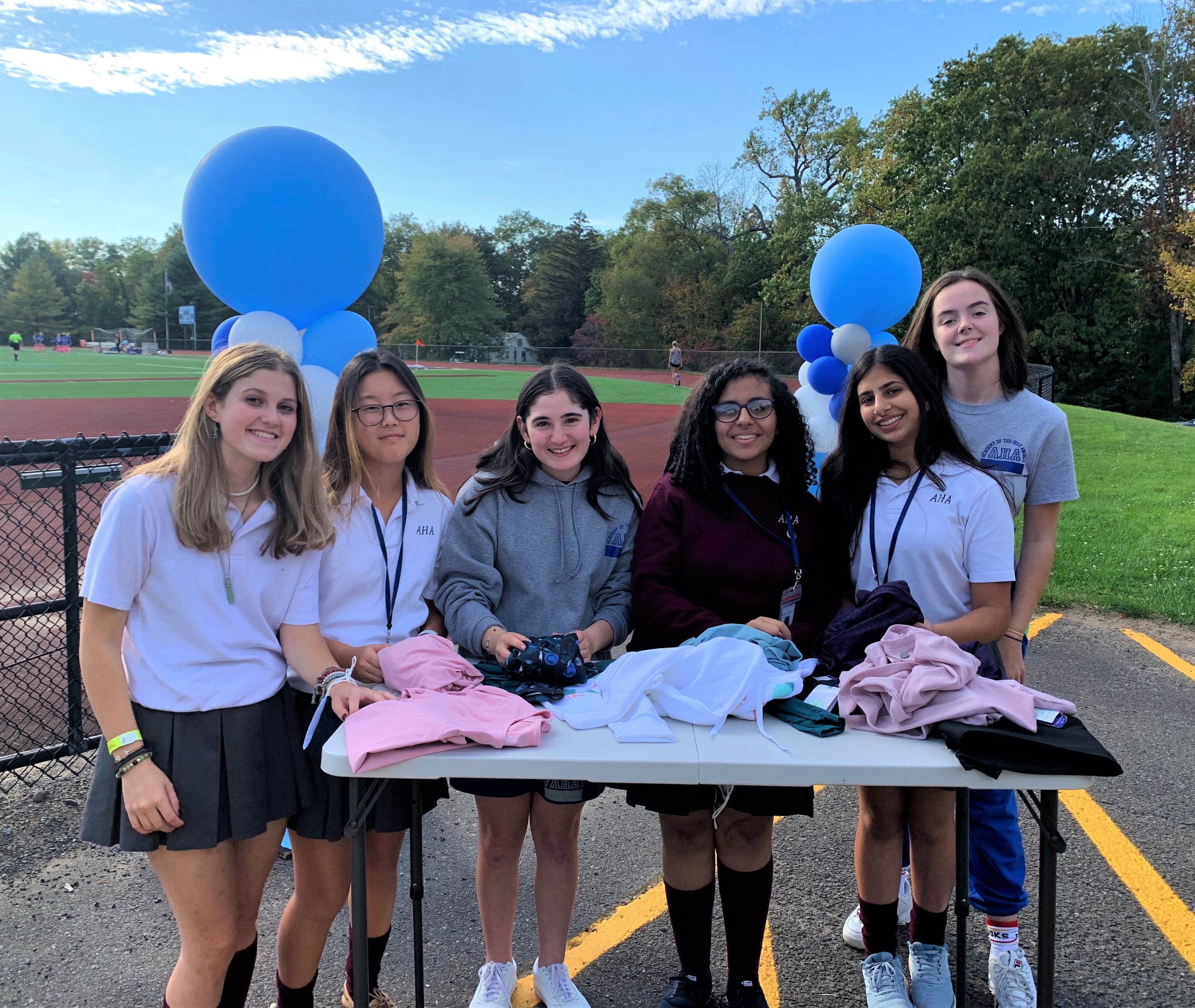 Fine and performing artists Natalia, Anna, Julia, Rachel, Shivani, and Fiona sort donations in advance of the Angels in the Arts