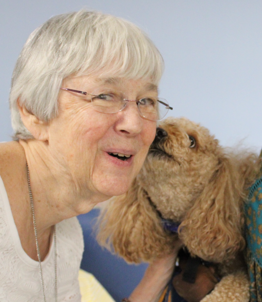 photo of Cooper the Dog gives a kiss to Sister