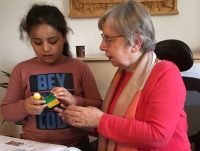Sister Judit Nötstalles SSND helping Shahad with her homework.