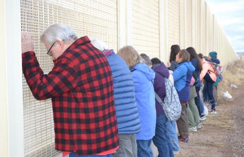 Praying at the border wall in Arizona